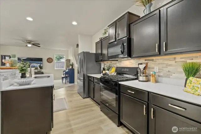 Kitchen has LVP Flooring installed in Oct. 2023, Quartz countertops, Brand new Range in May 2025, New Refrigerator in Dec. 2023, Undermount Deep Basin Stainless Steel Double Sink, Enormous Pantry