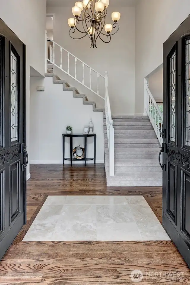 Grand entry way. Notice the rich dark refinished hardwood floors