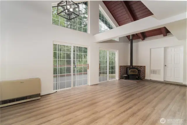 Living room with nice wood stove!  Large vaulted ceilings