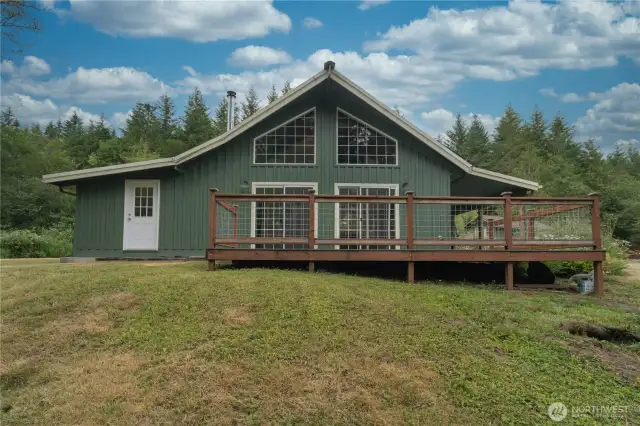 Large rear deck overlooking back yard with see through railings
