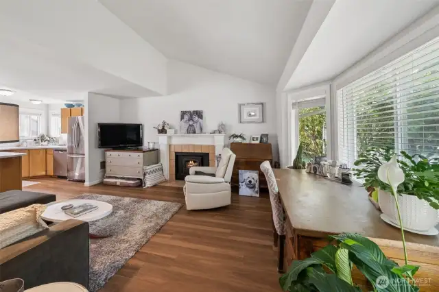Spacious living room with vaulted ceilings, perfect for relaxing or entertaining. Enjoy the charm of brand-new luxury vinyl plank flooring and the efficiency of new vinyl windows that bring in tons of natural light.