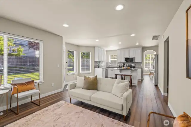 Large open kitchen with updated, stainless appliances, and island flowing to the family room and backyard patio.