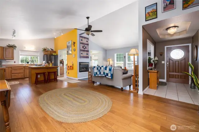The open living area features a vaulted ceiling, bamboo flooring, and lots of natural light.
