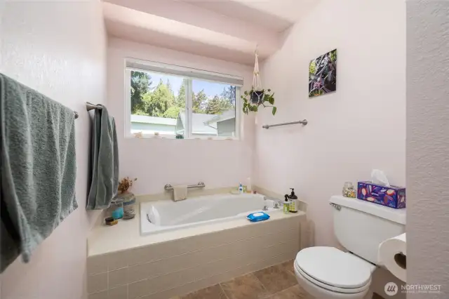 Primary bath includes a step-in shower and separate soaking tub.