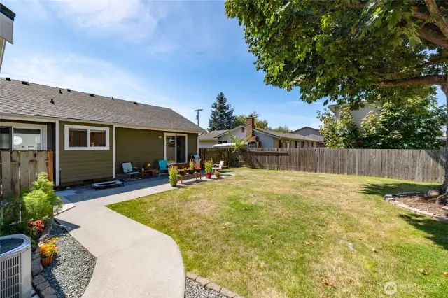 Fenced back yard with sunny southwest exposure, nice patio area, mature tree for shade.  AC unit shown at left.