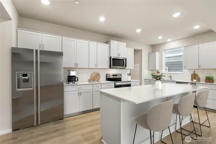 Built-in 48" fridge and lots of cabinets, in-wall oven & microwave. . Actual home is under construction and materials, colors, and finishes will vary. See site agent for details.