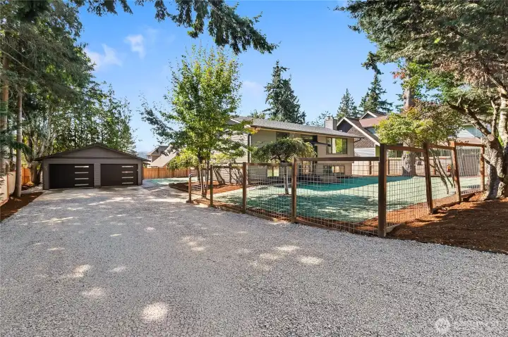 New landscaping with a large detached garage.