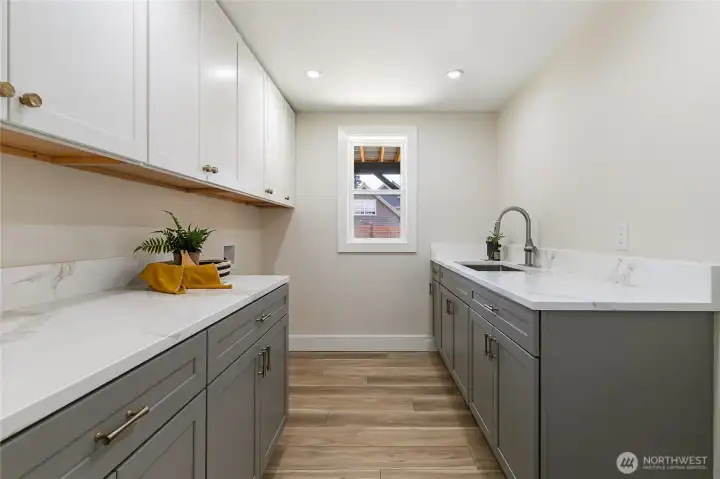 Laundry room with sink and room for a refrigerator.