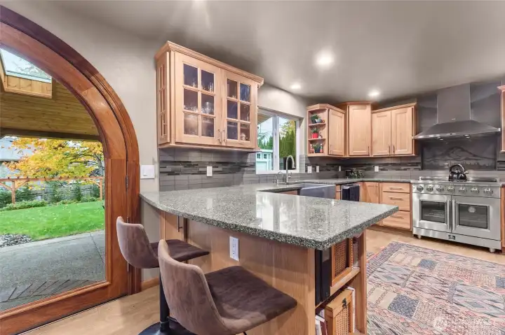 An amazing kitchen flanked by an equally amazing back yard.