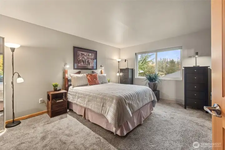 Primary bedroom is private and airy.