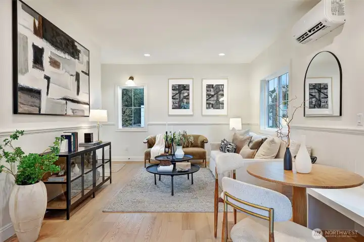 Sunlight fills a functional, open main level outfitted with engineered hardwood floors, mini-splits for heat and A/C, and a sleek chef's kitchen.