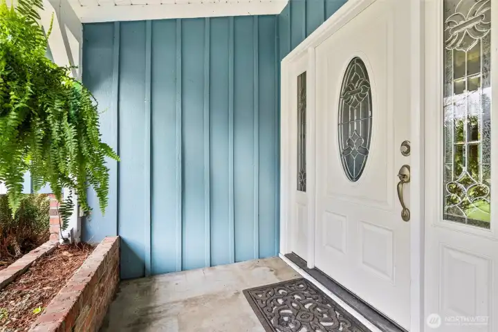 Charming covered porch offers a friendly welcome and sheltered entry into the home. The planter boxes are perfect for holiday decorations.