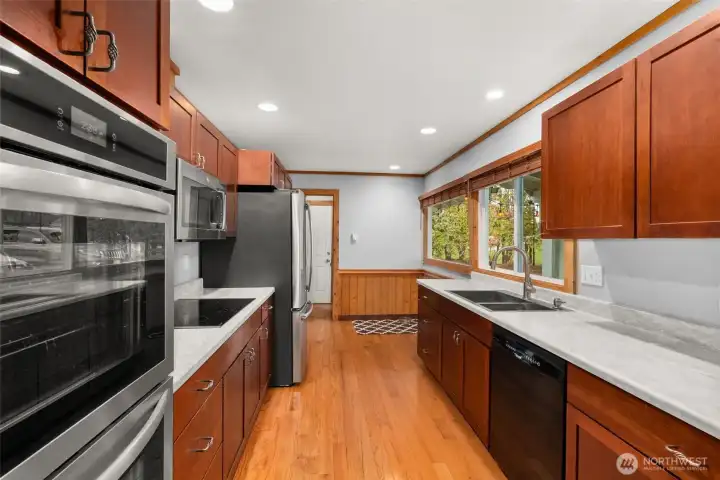 The double ovens and cook-top are nearly new while the refrigerator is only a few years old.