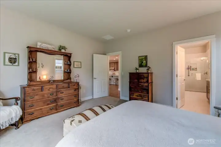 Primary Bedroom with Three Quarter Bathroom complete with His & Her Sinks, Glass Surround Shower, and Spacious Walk-In Closet