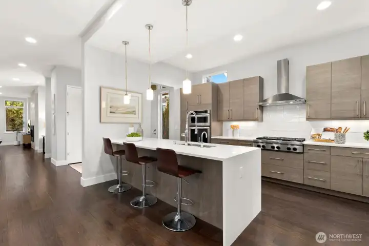 Large waterfall peninsula anchors the chef kitchen