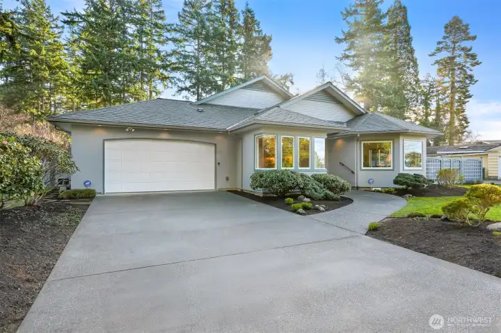 Inviting with long level driveway with parking for 5 cars and a 2-car garage.