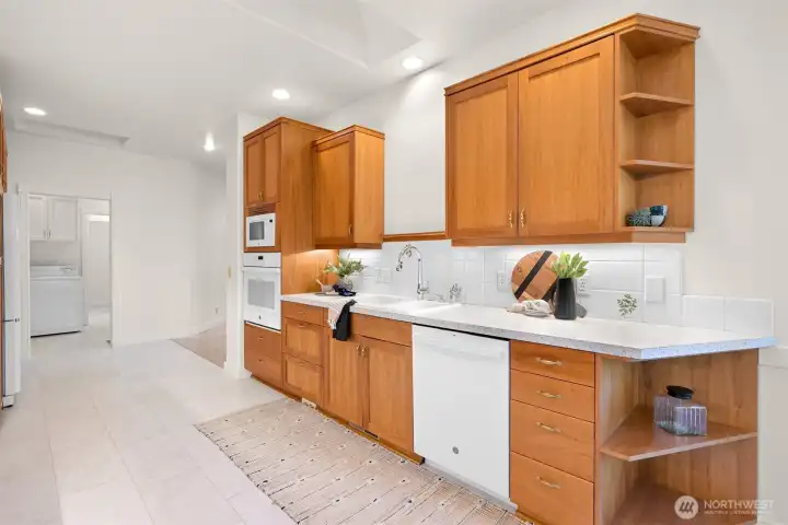 Abundant kitchen storage with cabinets featuring convenient rollouts.