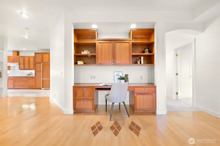 Built-in office desk credenza with integrated lighting for functionality.