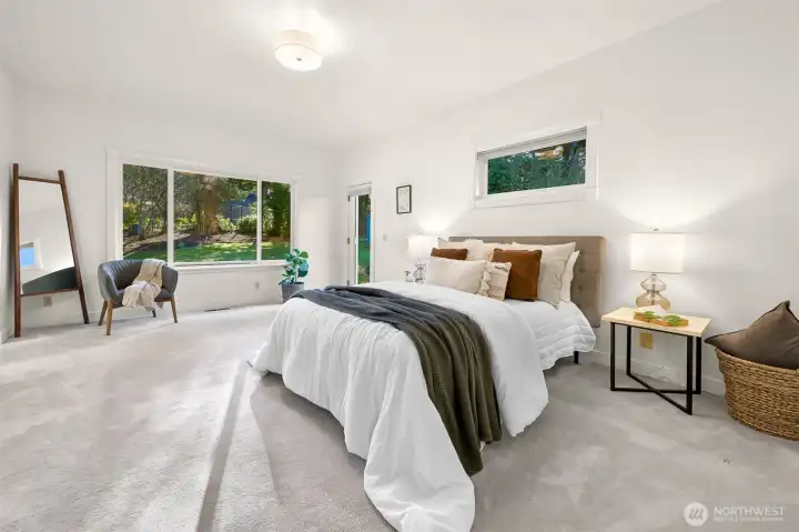 Expansive primary suite with backyard views and patio access.