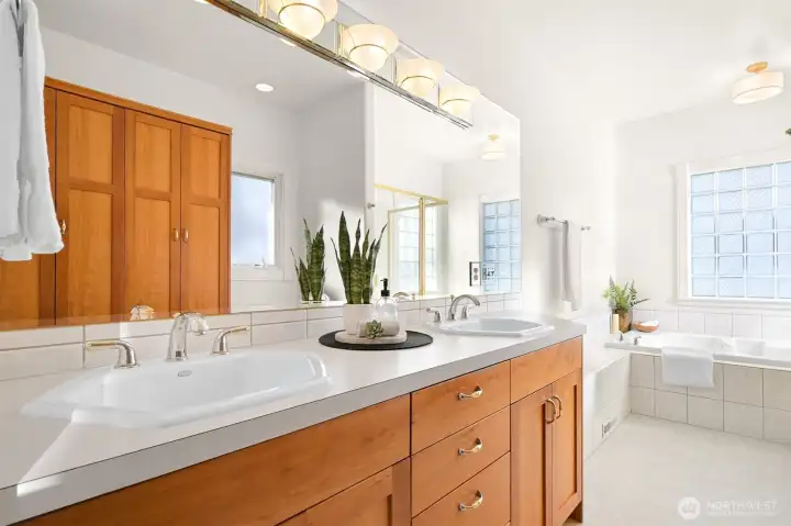 Light-filled primary bath with ample counter space and storage.