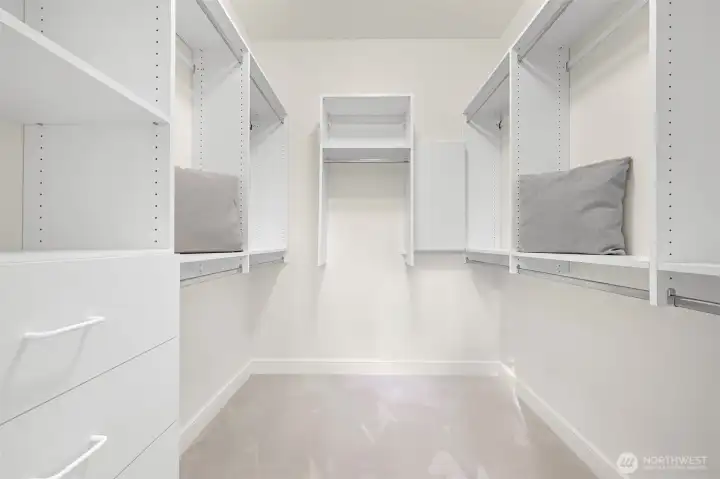 Custom walk-in closet offers ample space for your wardrobe.