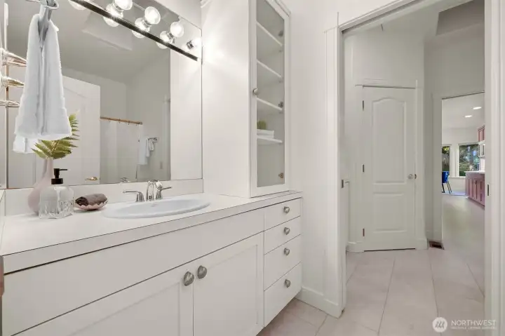 Full guest bath with convenient pocket door to laundry room.