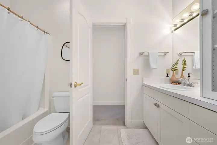 Guest bath conveniently serves both guests and family.