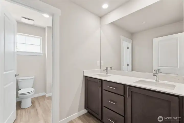 Main bath features double sinks and door to separte. Photo's are for representational purposes only. Colors and finishes may differ.