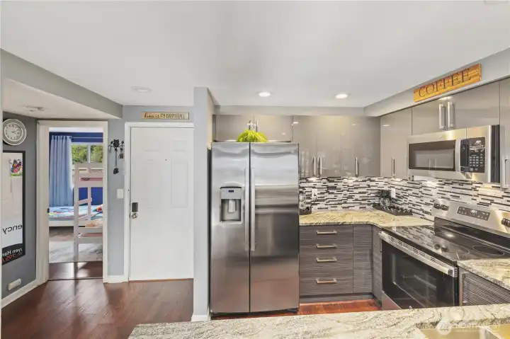 …as soon as walking in, the second bedroom on your right and a hard to miss gorgeous kitchen on your left.