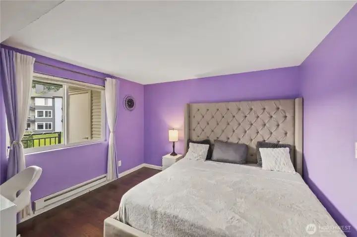 Spacious Primary Bedroom for a king sized bed, a vanity, a large window and designer’s colors for relaxation and enjoyment.