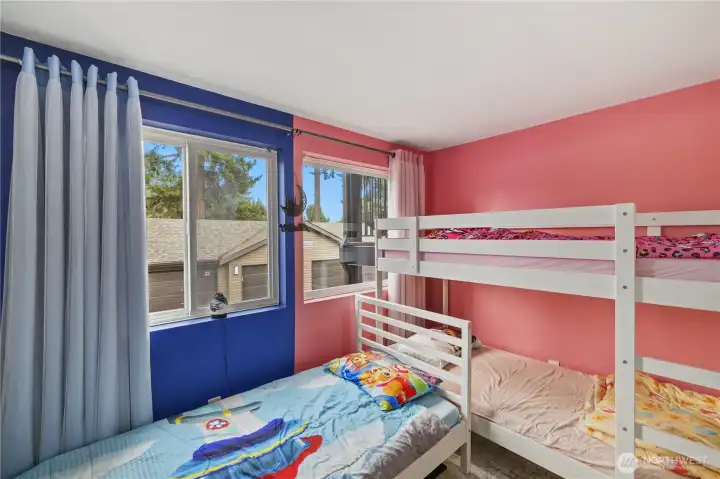 The second bedroom is large enough for a bunk bed, a single bed and a desk in designer’s colors.