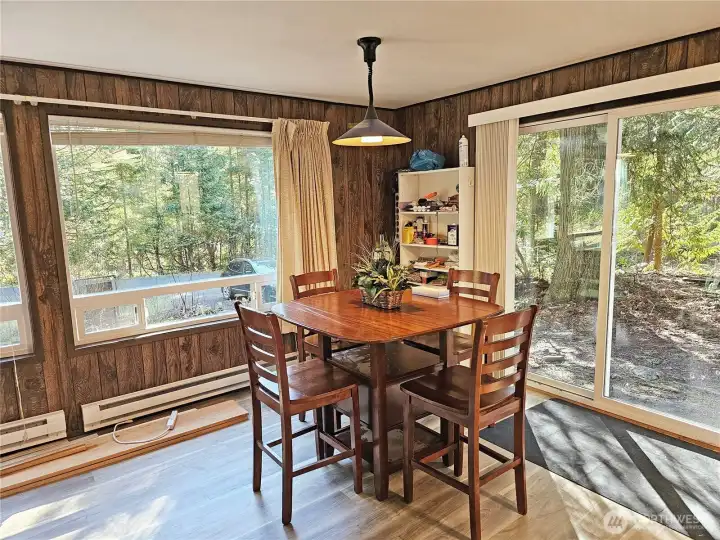 Just beyond the kitchen is a small dining space. Let the light in through the new picture windows and the sliding glass door!