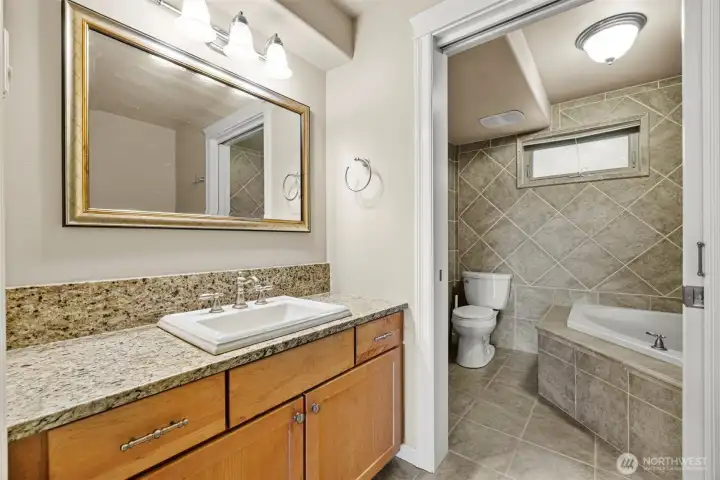 Primary bath with deep soaking tub, tiled heated floors.