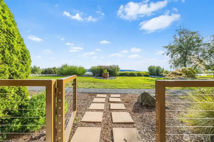 Gate out to grounds from covered patio space.