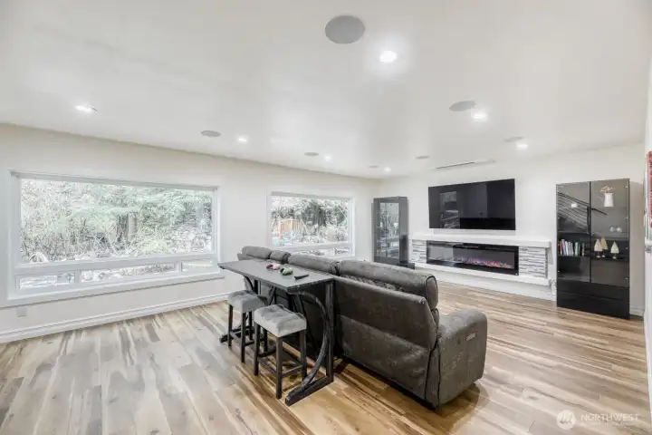 Open media room with electric fireplace puts out the heat or just the visual effect.