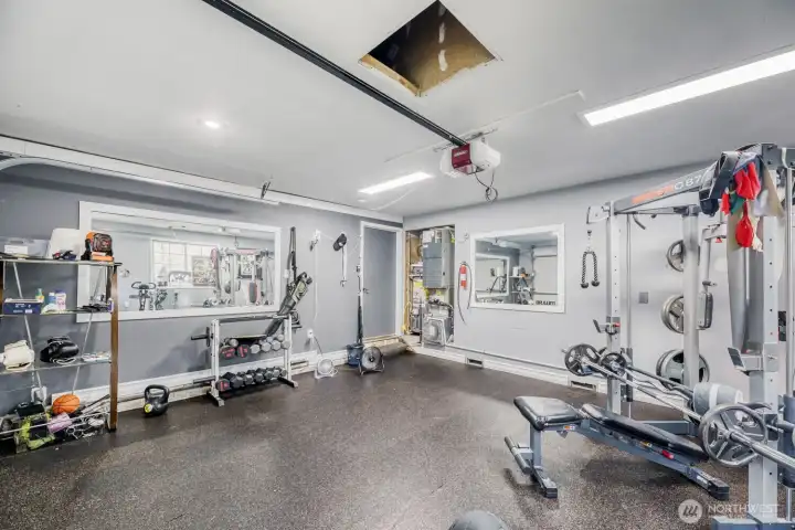 Double car garage is currently use as a personal gym with a finished floor & walls