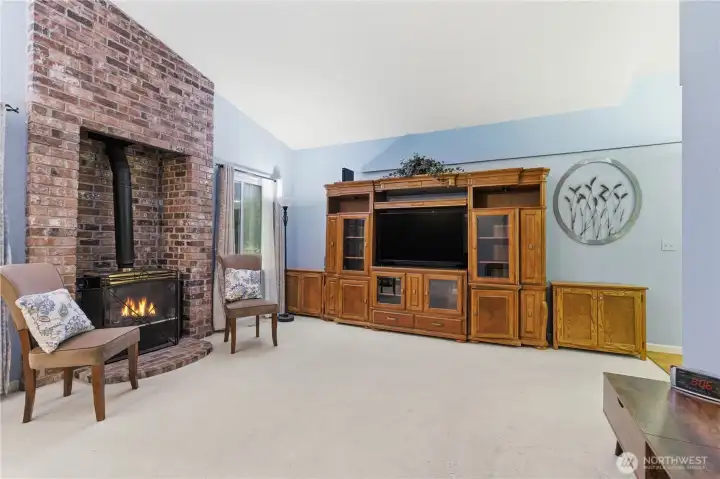Living room with beautiful brick gas stove area.