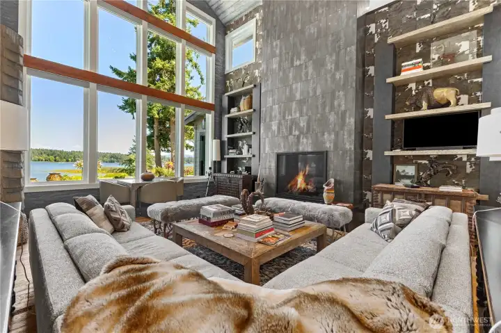 Great Room – Large high ceiling with pecky cypress  Gas fireplace with Italian tile floor to ceiling for mantel  Sunroom with gas fireplace and Phantom screens – includes a custom antler chandelier, three additional heaters for winter time use, wall television