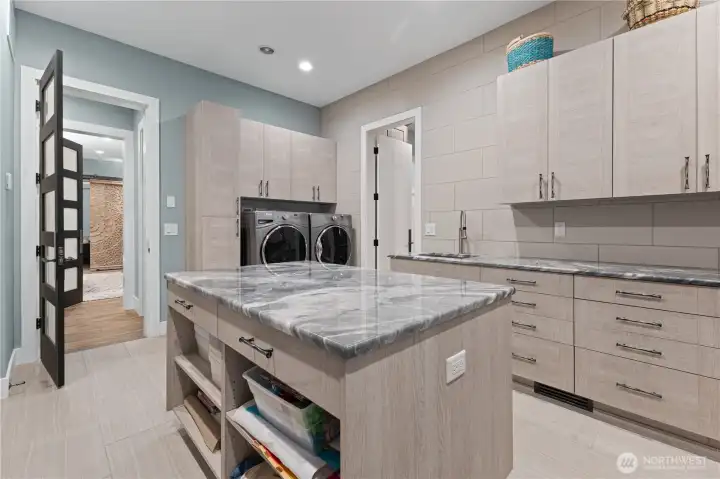 Downstairs laundry connected to primary bedroom closet