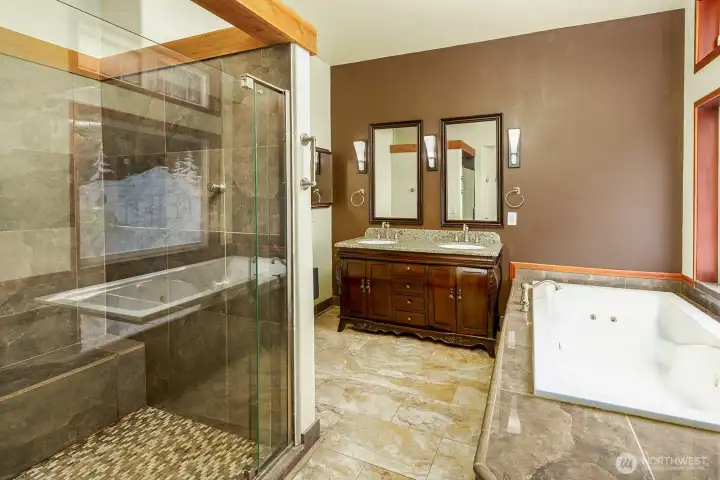 Bath off primary with large shower and separate bathtub.