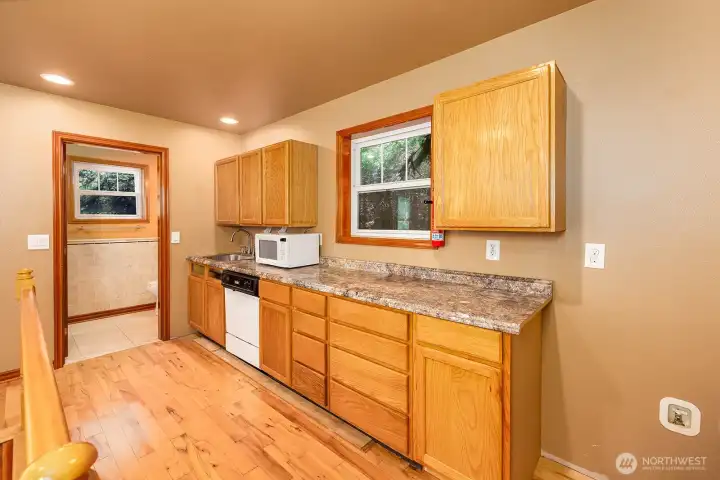 Wet bar with dishwasher, sink and microwave.