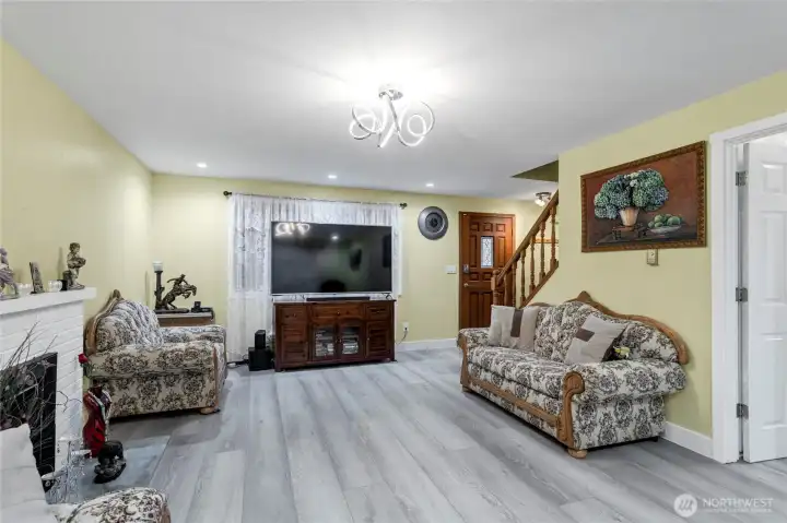 Another view of the Family room with fire place looking towards the front door