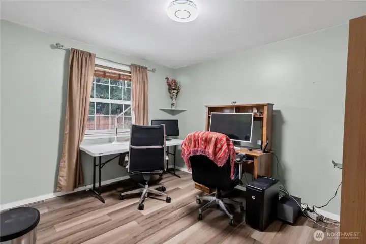 4th bedroom with beautiful flooring currently being used as an office