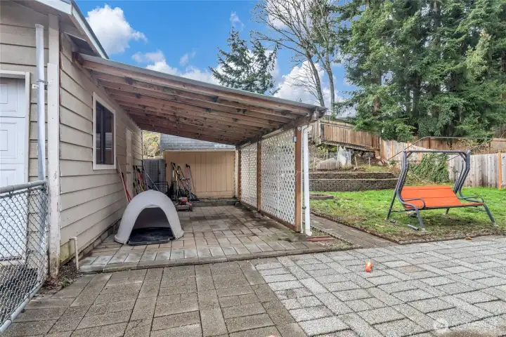View of the side of the garage with covered area for storage