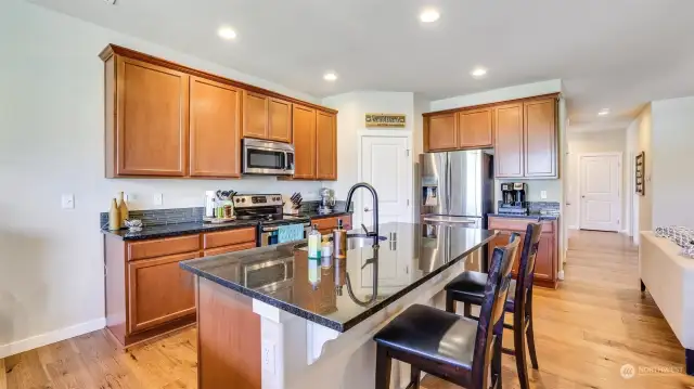 The kitchen offers a walk-in pantry, warm cabinetry, additional outlets and an abundance of storage.