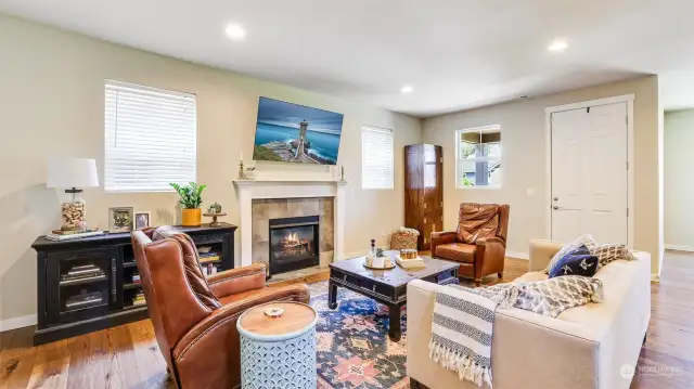 Living room boasts open floor plan, gas fireplace, recessing lighting, and stunning hardwood floors!