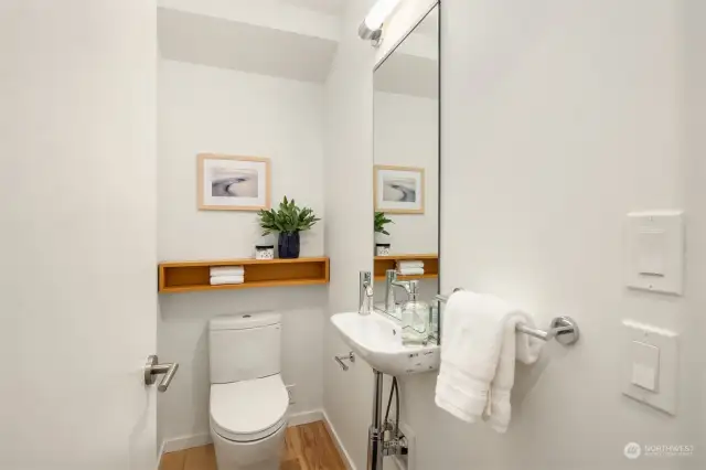 The main floor powder room adds both style and convenience, providing a tasteful and accessible amenity.