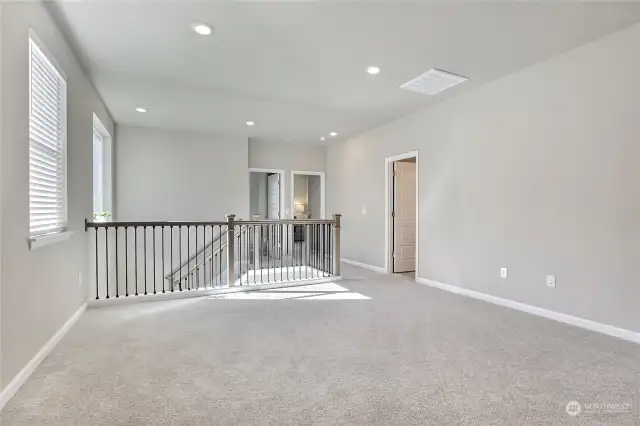 At the top of the stairs, you’re greeted by a spacious bonus room/loft filled with recessed and natural light. This versatile open area is perfect for a media room, home office, play area, or anything your lifestyle needs. Endless possibilities await in this inviting space!