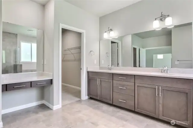 The dedicated makeup vanity area offers a private, stylish space to get ready, with a door that opens into an expansive walk-in closet. This thoughtful layout combines elegance and functionality, making daily routines a pleasure in this luxurious suite.