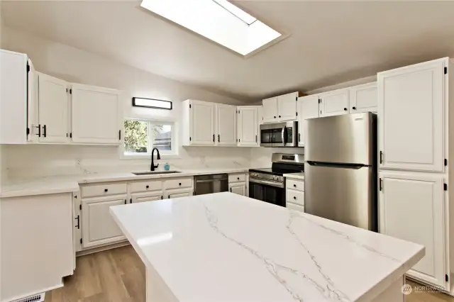 Kitchen features NEW quartz countertops & stainless-steel appliances.